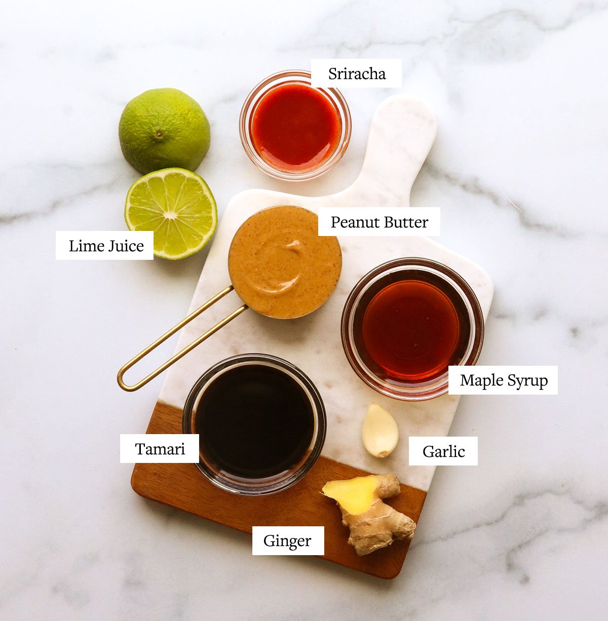 peanut sauce ingredients labeled on a marble cutting board.