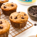 protein muffins on a cooling rack with chocolate chips.