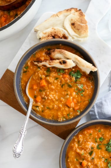 red lentil soup served with naan bread.