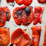 roasted red peppers on a baking sheet labeled for pinterest.