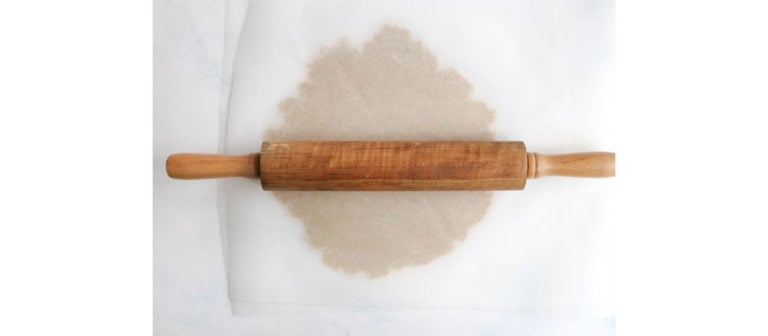 dough rolled out in parchment paper