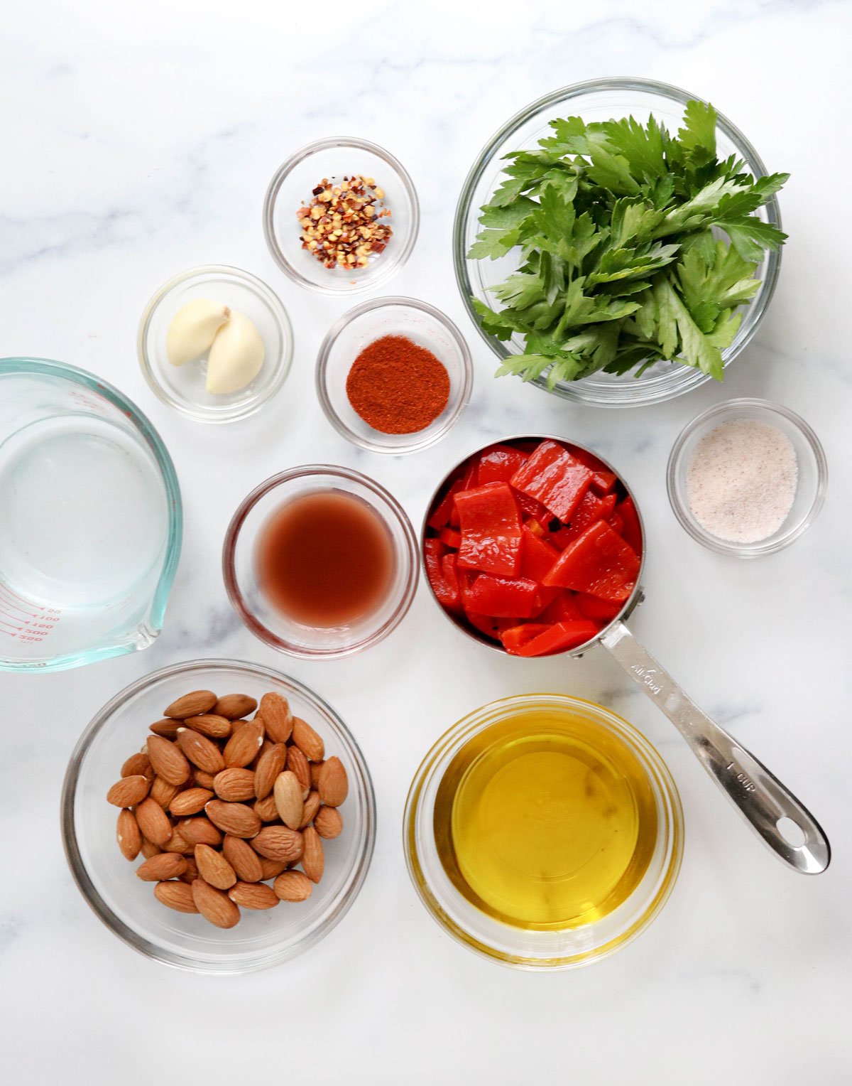 romesco sauce ingredients on white surface