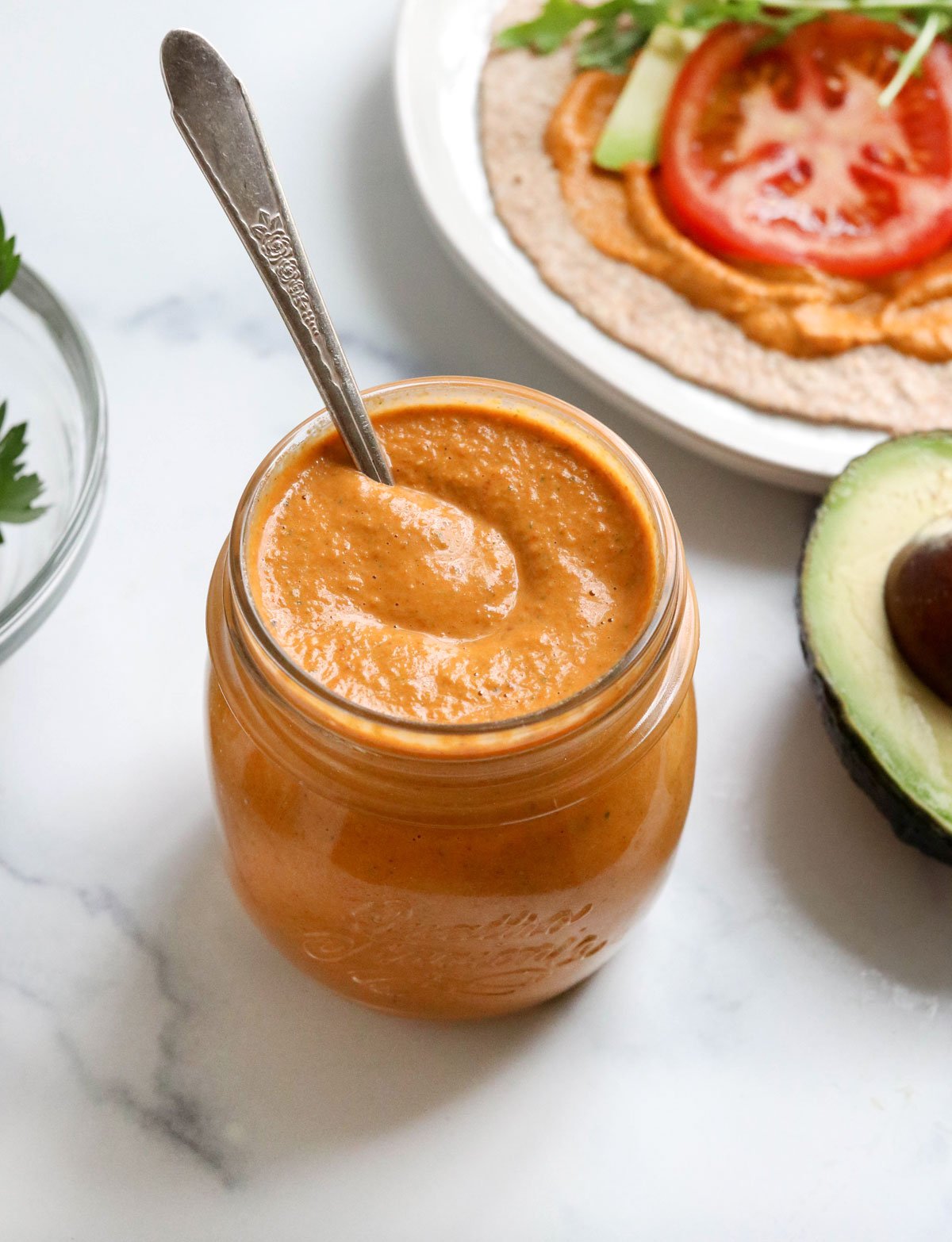 romesco sauce in jar with spoon