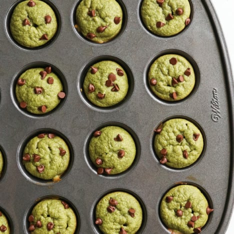 spinach muffins with mini chocolate chips on top in pan.