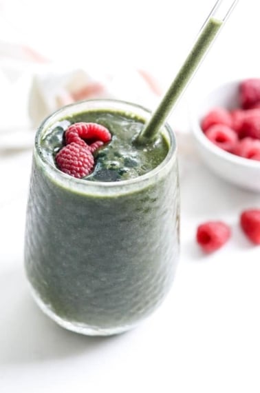 spirulina smoothie with raspberries on top