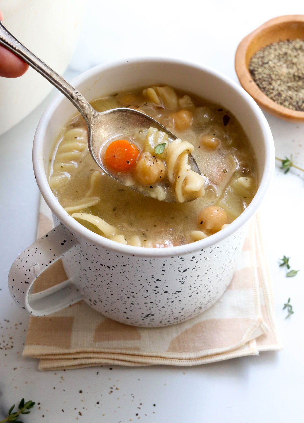 chickpea noodle soup lifted on spoon