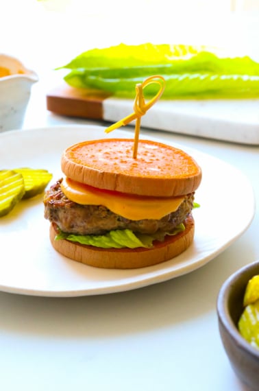 sweet potato slider with toothpick on a white plate.