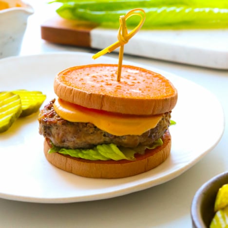 sweet potato slider with toothpick on a white plate.