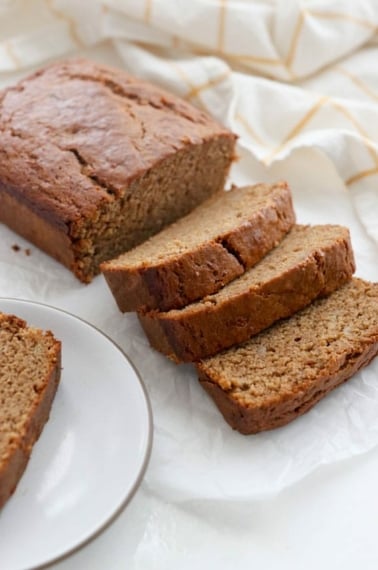 vegan banana bread sliced on a white surface