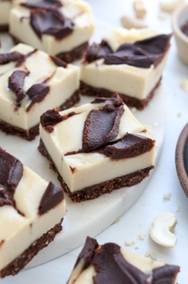 vegan chocolate cheesecake bars on white surface