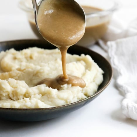 vegan gravy ladled over potatoes