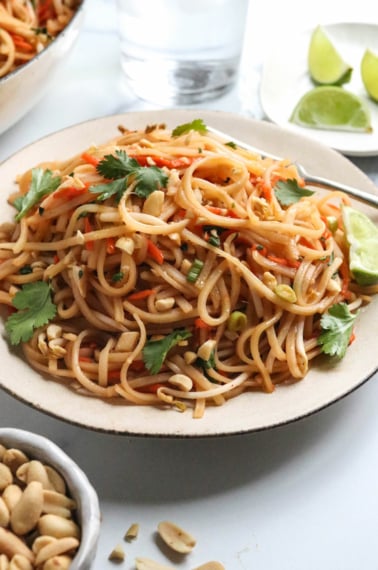 vegan pad thai noodles on a white plate