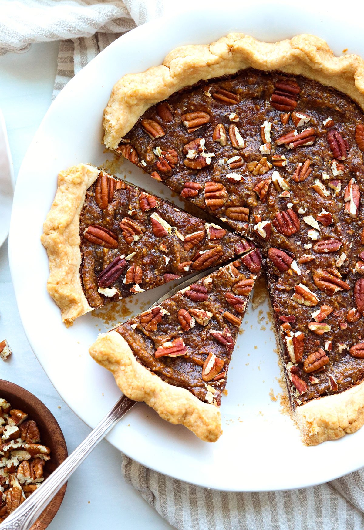 vegan pecan pie sliced in a pie plate.