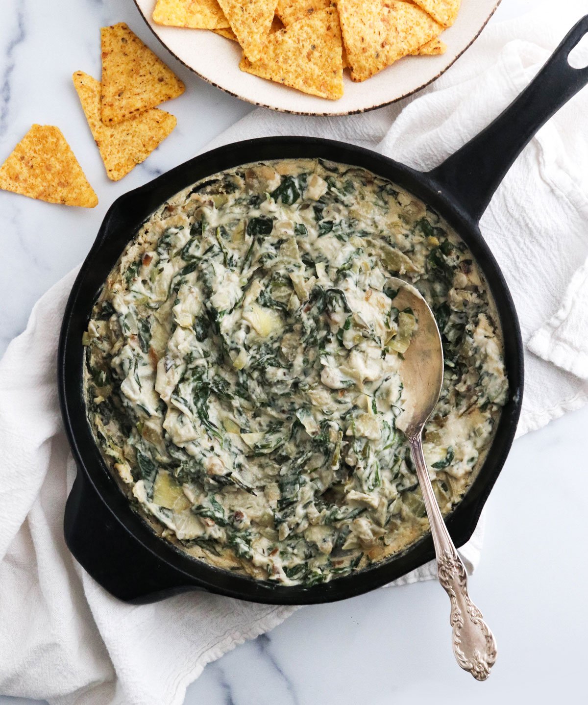 vegan spinach artichoke dip in skillet