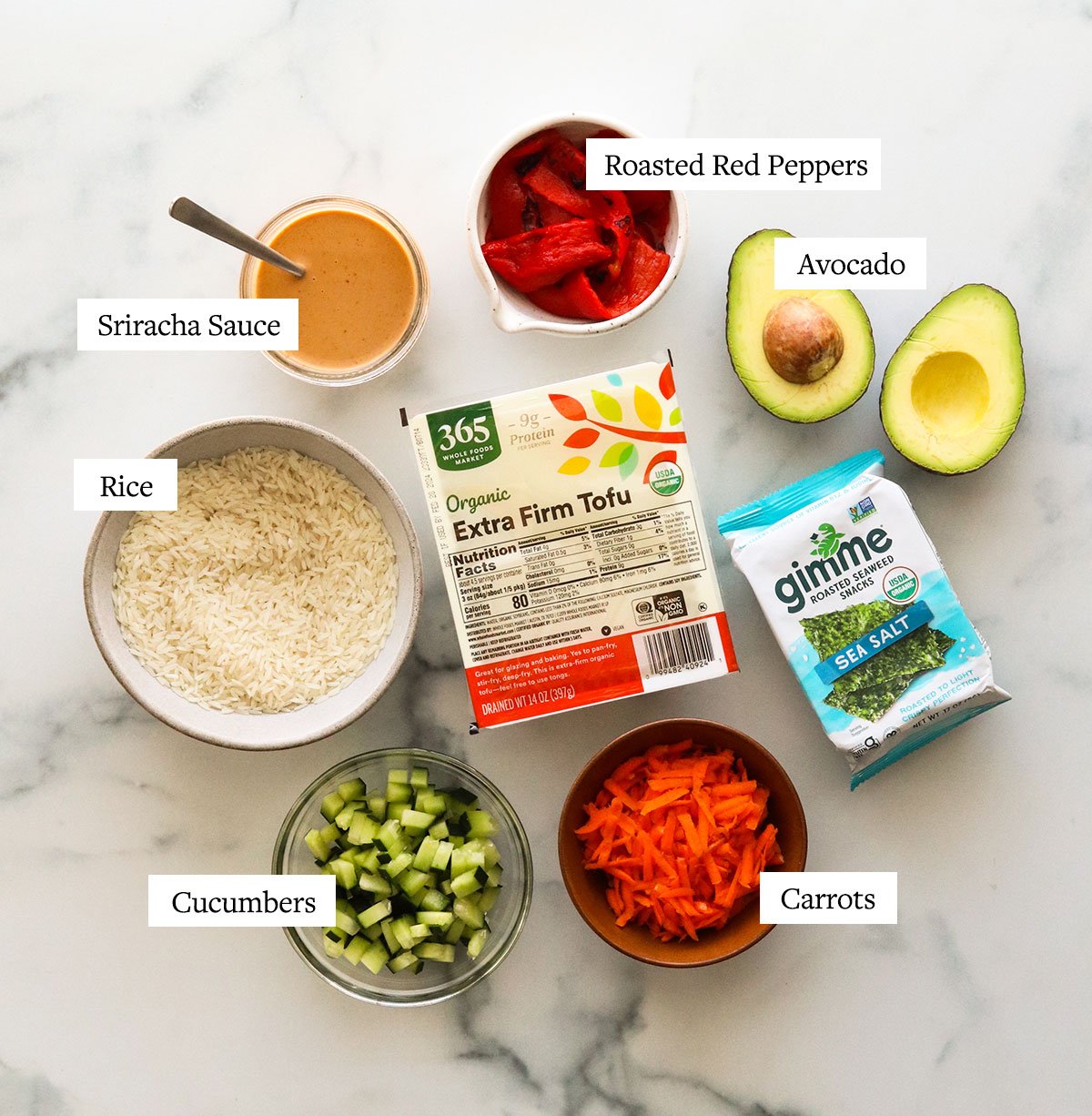 vegan sushi bowl ingredients labeled on a white surface.