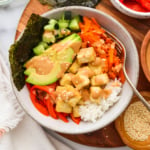 vegan sushi bowl topped with creamy tahini sriracha sauce.