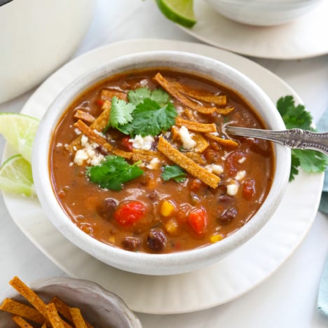 vegan tortilla soup topped with crispy tortilla strips.