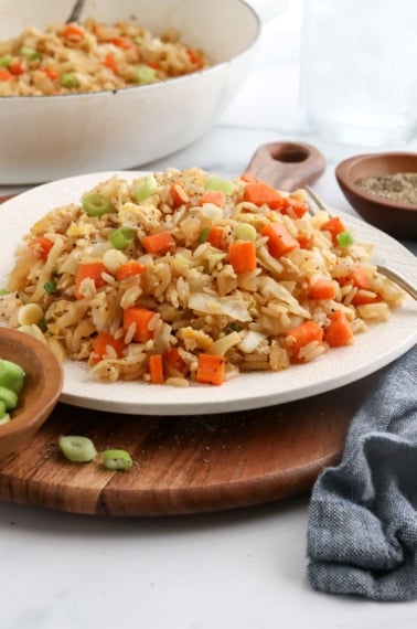 veggie fried rice on white plate with fork