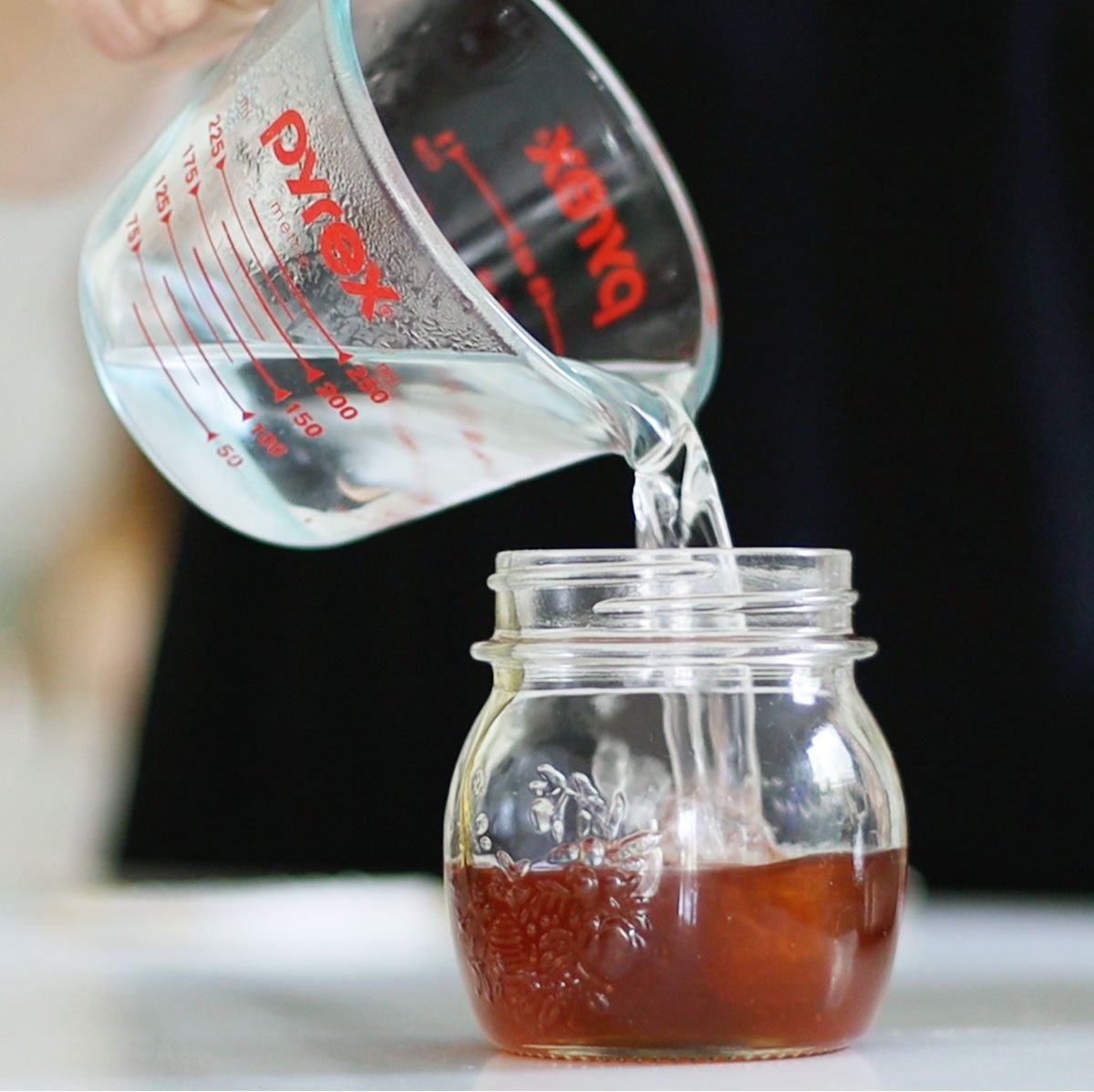 boiled water added to a jar of honey.